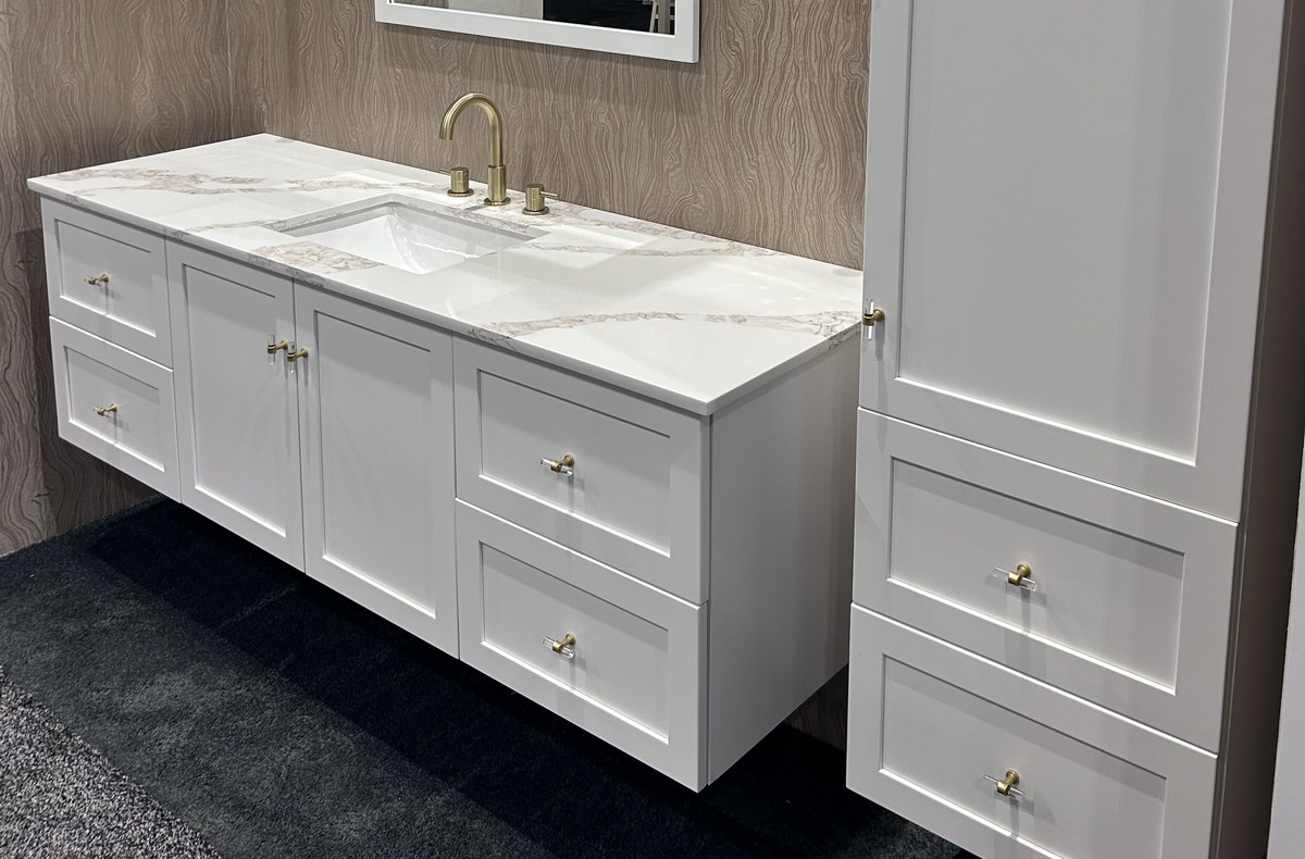 Chic Line slim shaker cabinets — a painted vanity and matching linen tower with quartz top and brass hardware